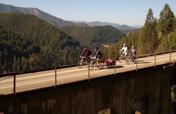 Scenic view of bikers crossing a bridge on the trail